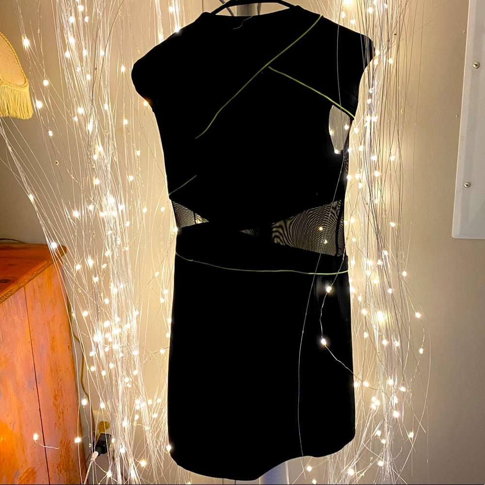 Black dress with neon green trim and mesh cutouts